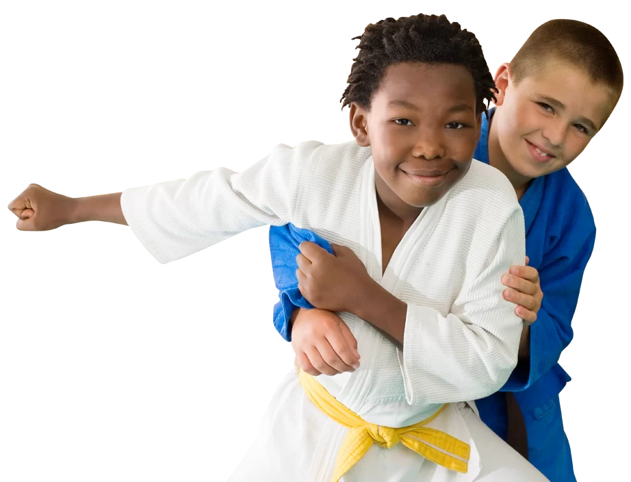 two young boys wrestling in karate uniforms